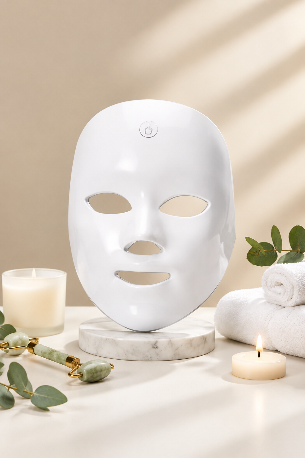 A woman holds a white LED facial therapy mask, with red light glowing from it. The image includes graphic overlays showing facial contouring benefits and a vertical row of color-changing face masks in different colors on the right.